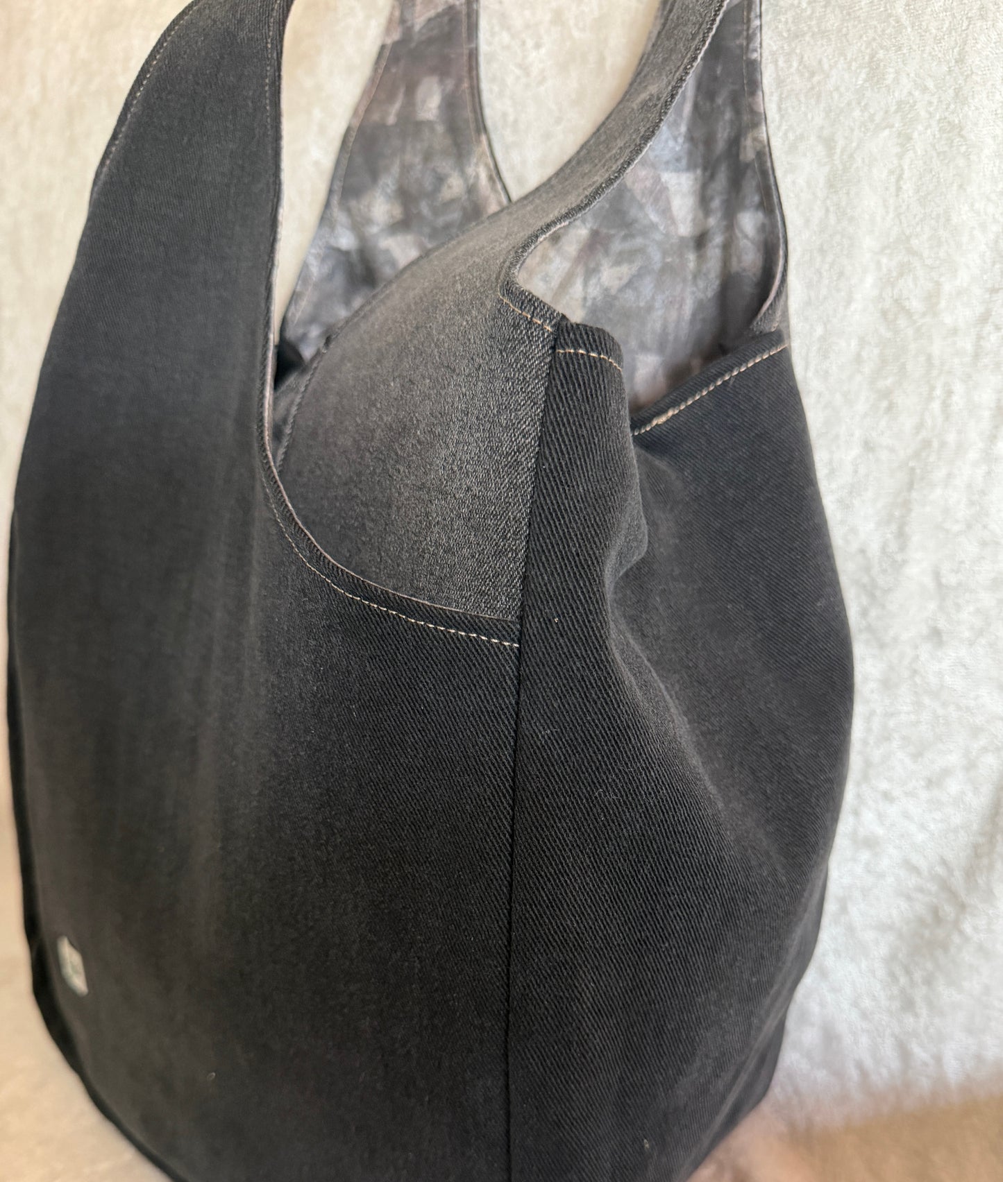 A black and gray tulip bag with deep pockets where the "petals" overlap. 