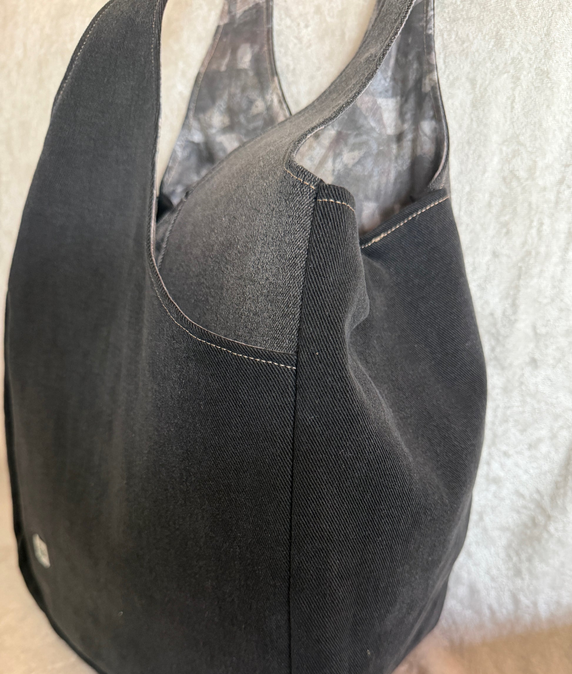 A black and gray tulip bag with deep pockets where the "petals" overlap. 